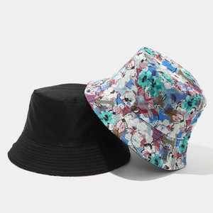 Close-up of double-sided bucket hats with black and vibrant floral pattern details
