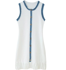 Close-up of contrast knit dress featuring gold buttons and blue frayed denim trim