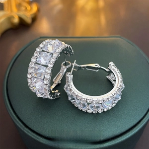 Exquisite silver hoop earrings with cubic zirconia on a luxury jewelry gift box