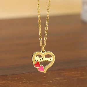 Detail of 18K gold heart necklace with Mama pendant and small red and pink hearts