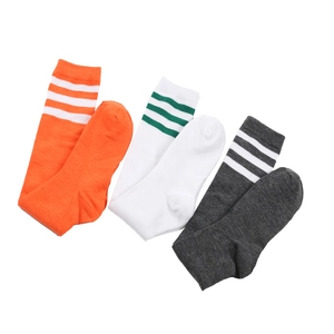Detailed view of women's JK style striped knee-high socks in orange, white, and grey colors.