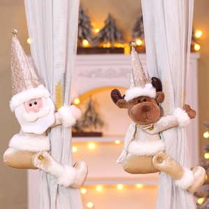 Detail of Santa and reindeer curtain tiebacks in champagne gold plush for festive decor