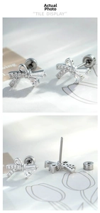 Detail of silver bow cartilage earring with sparkling zircon stones and screw back flat post