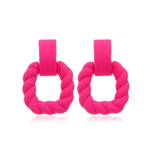 Detailed view of matte hot pink geometric square earrings with twisted texture design