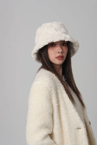 Close-up of the plush faux fur texture and checkerboard pattern on the white bucket hat