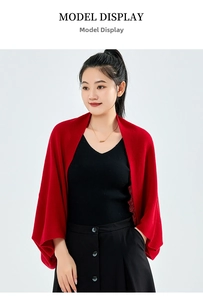 Detail of red cashmere knit shawl with soft texture and elegant draped open front design