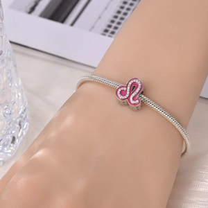 Silver snake chain bracelet with a pink enamel Leo zodiac charm and sparkling crystals