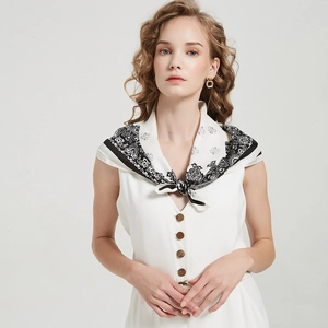 Detail of silk-like square scarf with black and white Paisley pattern tied on neck