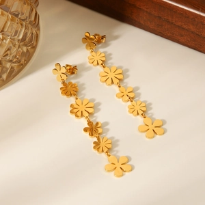 Detailed view of long 18k gold plated stainless steel daisy tassel flower earrings