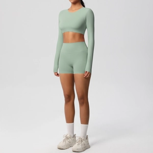 Detail of grey-green yoga set with long sleeve crop top and high waist shorts