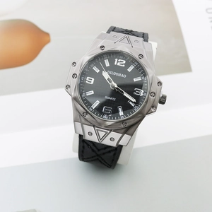 Close-up of industrial silver polygonal watch case with decorative screws and black leather strap