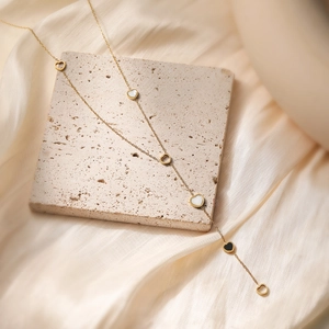 Minimalist 18K gold plated heart pendant necklace displayed on a textured stone surface