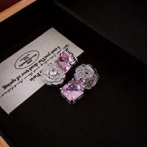 Detailed shot of pink square gemstone earrings with camellia flower diamond-set design
