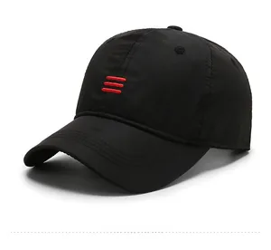 Detail view of black baseball cap featuring three red parallel embroidered stripes