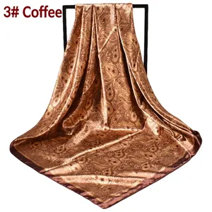 Close-up of brown paisley print satin scarf showing silky texture and elegant drape