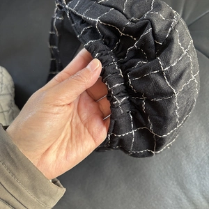Detailed view of checkered linen beret with elasticated hem for adjustable comfort