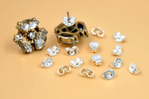 Detail view of silver earring butterfly backings with 925 hallmarks and jewelry set
