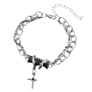 Detail of layered silver chain bracelet with rectangular black gem and cross pendant
