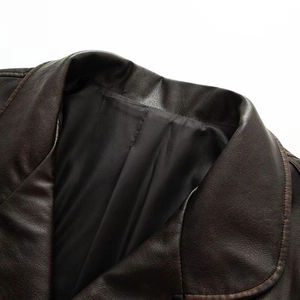 Detailed close-up of dark brown leather jacket collar with high-quality interior lining