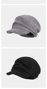 Detail view of grey and black pleated berets with textured faux suede fabric finish