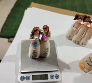 Weight measurement of 90g for friendship resin sculpture featuring two women hugging