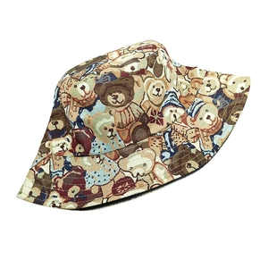 Close-up of cute cartoon bear pattern and woven texture on a sun bucket hat