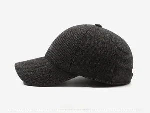 Side view of dark gray winter baseball cap showing thick knitted wool texture and stitching