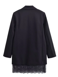 Detail of the back view of a black blazer dress featuring delicate lace hem stitching