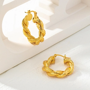 Minimalist twisted rope hoop earrings with 18K gold plating on architectural stand