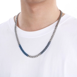 Close-up of a high-quality dual-tone silver and blue chunky stainless steel Cuban chain necklace