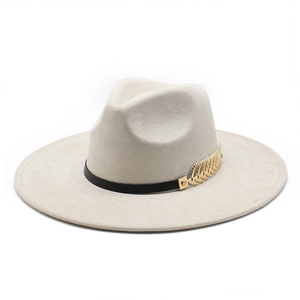 Detail of off-white wide brim jazz hat with black ribbon and gold leaf metal accessory
