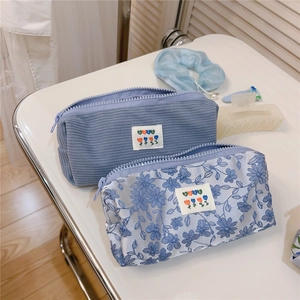 Blue corduroy and floral mesh storage pouches shown with matching hair accessories