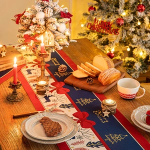 Christmas table runner with reindeer and trees, festive holiday decor on wooden table