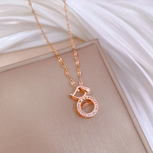 Detail of rose gold puppy necklace with sparkling crystals and a moving diamond center