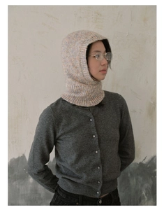 Close-up of knit balaclava hood in flecked beige yarn showing soft texture and cozy fit