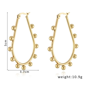 Detailed view of U-shaped gold earrings with measurements 5cm by 3.7cm and weight 10.9g