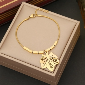 Golden maple leaf pendant bracelet with snake chain and rectangular beads in a gift box