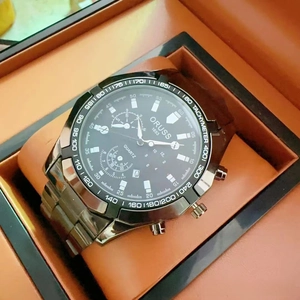Detail view of quartz watch with black dial and tachymeter in premium gift box