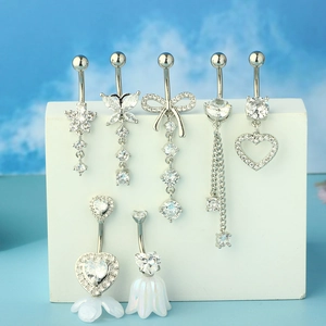 Detailed view of silver stainless steel belly rings with sparkling zircon in various shapes