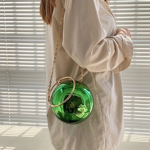 Fashionable green acrylic sphere evening bag with gold ring handle and chain strap