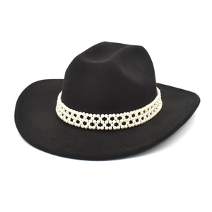 Close-up of pearl woven band detail on black wool felt western jazz fedora hat