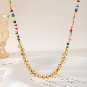 Colorful natural stone beaded necklace with 18k gold plated metal beads on white tray