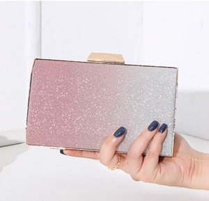Detail of pink to silver gradient sequin evening clutch with golden metal clasp closure