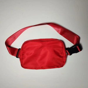Close-up of red waterproof nylon running belt with adjustable strap and buckle