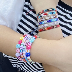 Bohemian woven seed bead bracelets set with acrylic smiley face, heart and moon charms
