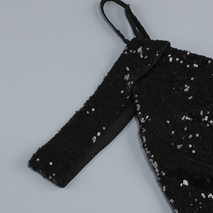 Detail shot of high-density black sequins and thin shoulder strap on a sexy long dress