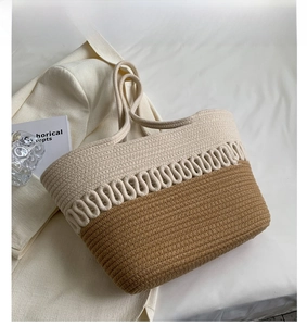 Detail of khaki and beige woven tote bag with wavy patterns on a textured fabric