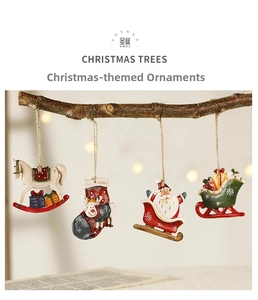 Close-up of four resin Christmas ornaments like rocking horse and reindeer on tree branch