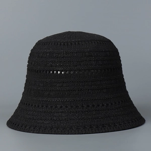 Close-up of the intricate hollow-out knit pattern and texture on a black bucket hat