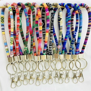 Detailed view of colorful hand-woven ethnic pattern keychains with silver metal clasps